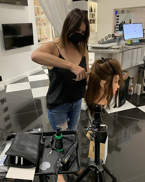 Stylist working on mannequin hair
